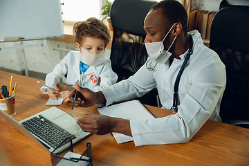 Image showing Little caucasian boy as a doctor consulting for patient, working in cabinet, close up