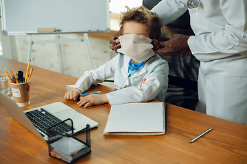 Image showing Little caucasian boy as a doctor consulting for patient, working in cabinet, close up