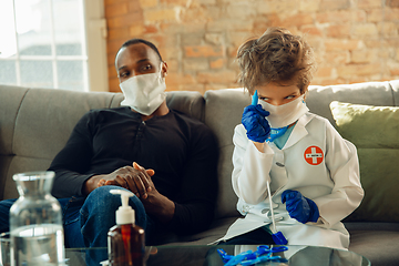 Image showing Little caucasian boy as a doctor consulting for patient, working in cabinet, close up