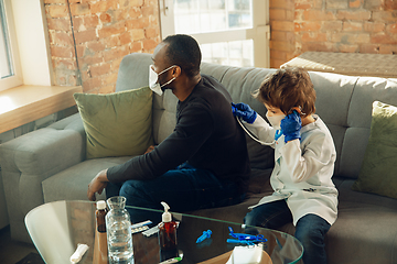 Image showing Little caucasian boy as a doctor consulting for patient, working in cabinet, close up