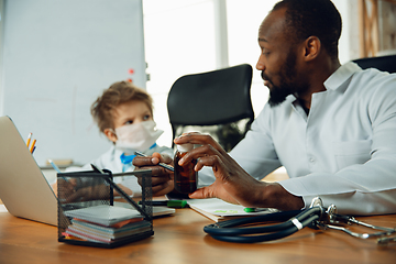 Image showing Little caucasian boy as a doctor consulting for patient, working in cabinet, close up