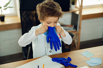 Image showing Little caucasian boy as a doctor consulting for patient, working in cabinet, close up