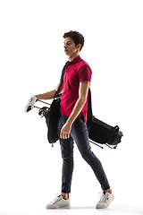 Image showing Golf player in a red shirt training, practicing isolated on white studio background