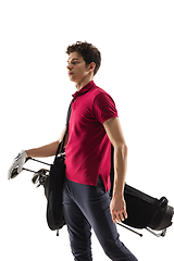 Image showing Golf player in a red shirt training, practicing isolated on white studio background