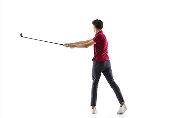 Image showing Golf player in a red shirt taking a swing isolated on white studio background