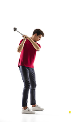 Image showing Golf player in a red shirt training, practicing isolated on white studio background