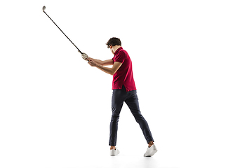 Image showing Golf player in a red shirt taking a swing isolated on white studio background