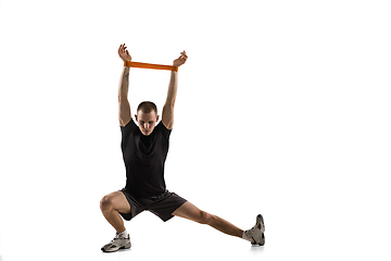 Image showing Young caucasian male model in action, motion isolated on white background. Concept of sport, movement, energy and dynamic, healthy lifestyle. Training, practicing.