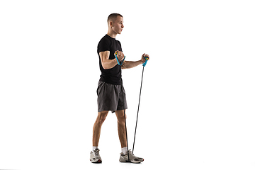 Image showing Young caucasian male model in action, motion isolated on white background. Concept of sport, movement, energy and dynamic, healthy lifestyle. Training, practicing.