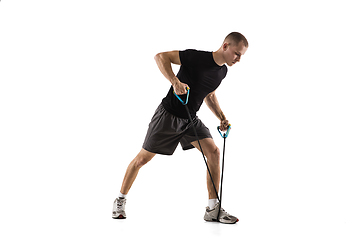 Image showing Young caucasian male model in action, motion isolated on white background. Concept of sport, movement, energy and dynamic, healthy lifestyle. Training, practicing.