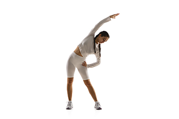 Image showing Young caucasian female model in action, motion isolated on white background. Concept of sport, movement, energy and dynamic, healthy lifestyle. Training, practicing.