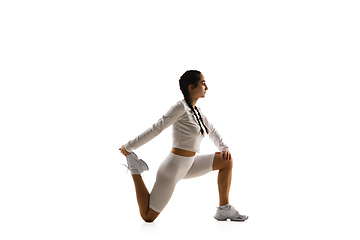 Image showing Young caucasian female model in action, motion isolated on white background. Concept of sport, movement, energy and dynamic, healthy lifestyle. Training, practicing.