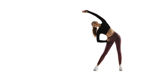 Image showing Young caucasian female model in action, motion isolated on white background. Concept of sport, movement, energy and dynamic, healthy lifestyle. Training, practicing.