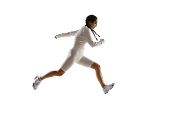 Image showing Young caucasian female model in action, motion isolated on white background. Concept of sport, movement, energy and dynamic, healthy lifestyle. Training, practicing.