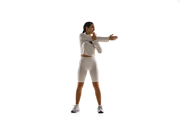 Image showing Young caucasian female model in action, motion isolated on white background. Concept of sport, movement, energy and dynamic, healthy lifestyle. Training, practicing.