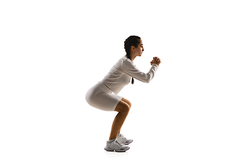 Image showing Young caucasian female model in action, motion isolated on white background. Concept of sport, movement, energy and dynamic, healthy lifestyle. Training, practicing.