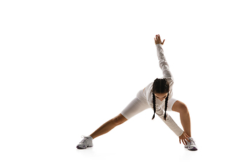 Image showing Young caucasian female model in action, motion isolated on white background. Concept of sport, movement, energy and dynamic, healthy lifestyle. Training, practicing.