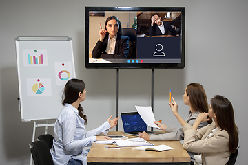 Image showing Brainstorm. Young colleagues talking, working in videoconference with co-workers at office or living room. Online business, education during quarantine.