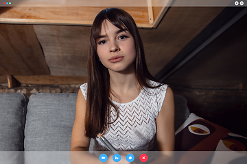 Image showing Young woman talking, working in videoconference with co-workers at office or living room. Online business, education during quarantine.