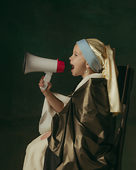 Image showing Medieval little girl as a lady with a pearl earring on dark studio background. Concept of comparison of eras, childhood. Stylish creative design, art vision, new look of artwork.