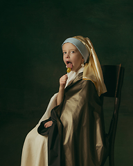 Image showing Medieval little girl as a lady with a pearl earring on dark studio background. Concept of comparison of eras, childhood. Stylish creative design, art vision, new look of artwork.