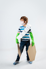 Image showing Little caucasian boy as a warrior in fight with coronavirus pandemic, with a shield, a sword and a toilet paper bandoleer, preparing