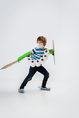 Image showing Little caucasian boy as a warrior in fight with coronavirus pandemic, with a shield, a sword and a toilet paper bandoleer, protecting