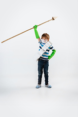 Image showing Little caucasian boy as a warrior in fight with coronavirus pandemic, with a face mask, a spear and a toilet paper bandoleer, attacking