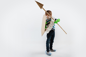 Image showing Little caucasian boy as a warrior in fight with coronavirus pandemic, with a shield, a spear and a toilet paper bandoleer, attacking