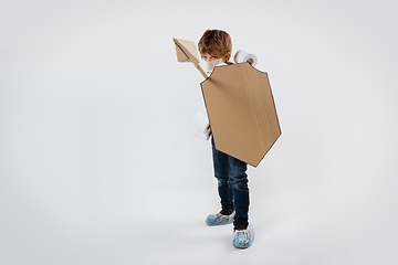 Image showing Little caucasian boy as a warrior in fight with coronavirus pandemic, with a shield, a spear and a toilet paper bandoleer, attacking