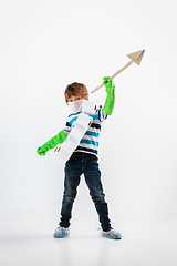 Image showing Little caucasian boy as a warrior in fight with coronavirus pandemic, with a face mask, a spear and a toilet paper bandoleer, attacking