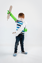 Image showing Little caucasian boy as a warrior in fight with coronavirus pandemic, with a face mask, a thermometer, sanitizer and a toilet paper bandoleer