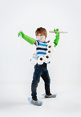 Image showing Little caucasian boy as a warrior in fight with coronavirus pandemic, with a face mask, a thermometer, sanitizer and a toilet paper bandoleer