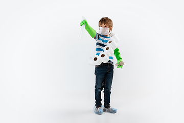 Image showing Little caucasian boy as a warrior in fight with coronavirus pandemic, with a face mask, a thermometer, sanitizer and a toilet paper bandoleer