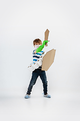 Image showing Little caucasian boy as a warrior in fight with coronavirus pandemic, with a shield, a sword and a toilet paper bandoleer, protecting