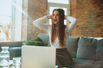 Image showing Caucasian woman singing during online concert at home isolated and quarantined, impressive improvising, dancing