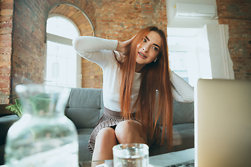 Image showing Caucasian woman singing during online concert at home isolated and quarantined, impressive improvising, dancing