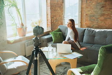 Image showing Caucasian woman singing during online concert at home isolated and quarantined, impressive improvising, dancing