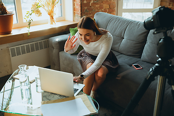 Image showing Caucasian woman singing during online concert at home isolated and quarantined, tuning streaming