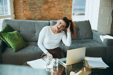 Image showing Caucasian woman singing during online concert at home isolated and quarantined, impressive improvising, dancing