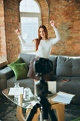 Image showing Caucasian woman singing during online concert at home isolated and quarantined, impressive improvising, dancing