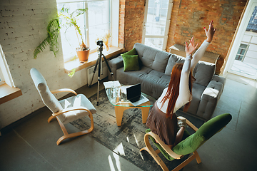 Image showing Caucasian woman singing during online concert at home isolated and quarantined, impressive improvising, dancing