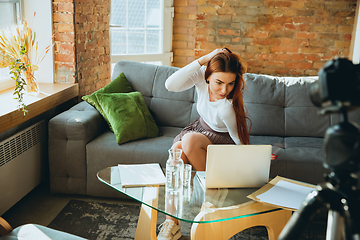 Image showing Caucasian woman singing during online concert at home isolated and quarantined, impressive improvising, dancing