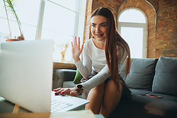 Image showing Caucasian woman singing during online concert at home isolated and quarantined, greeting