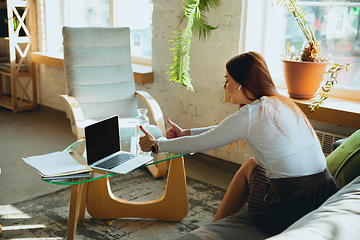 Image showing Caucasian woman singing during online concert at home isolated and quarantined, impressive improvising, dancing