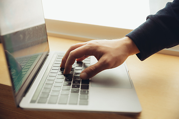 Image showing Close-up of male fingers typing a business document, note or search key on the laptop