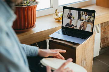 Image showing Caucasian musician playing hand drum during concert at home isolated and quarantined, playing with the band in online streaming, conference