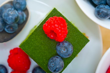 Image showing green tea matcha mousse cake with berries