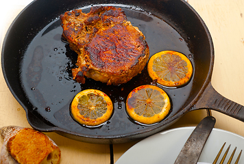 Image showing pork chop seared on iron skillet