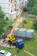 Image showing truck with hoisting crane loading the wagon